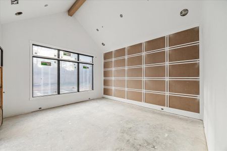 Primary bedroom with soaring vaulted ceiling and wall detail for a special design touch.