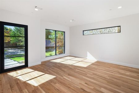 Unfurnished room featuring a healthy amount of sunlight and light hardwood / wood-style flooring