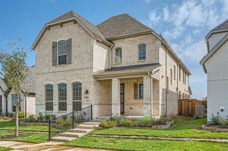 French country inspired facade with a front yard