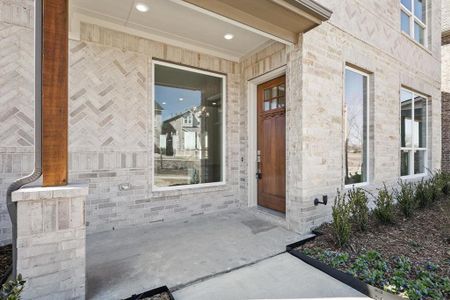 Property entrance featuring brick siding