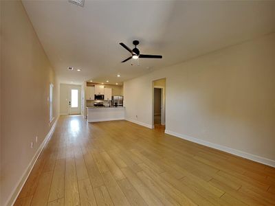 Unfurnished living room with ceiling fan and light hardwood / wood-style floors