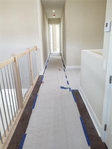 Upstairs hall way looks over to foyer. Photo from  previously built 
Cypress Model