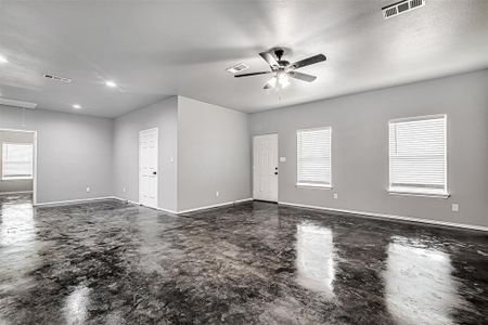 Unfurnished room featuring ceiling fan and a textured ceiling