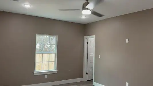 Unfurnished room with baseboards, wood finished floors, and a ceiling fan