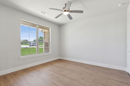 Unfurnished room featuring light hardwood / wood-style floors and ceiling fan