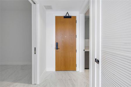 Looking back towards entry with large den on the left and huge laundry room to the right