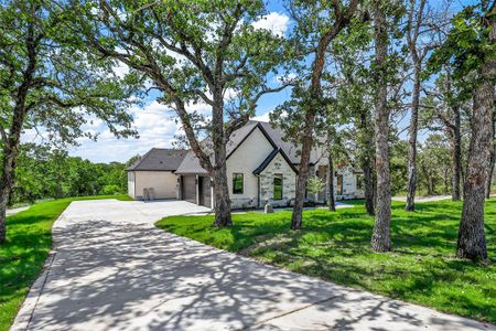 View of front of home with a garage and a front lawn