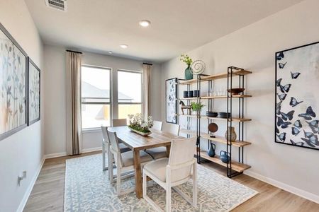 Dining space with light wood-style flooring, visible vents, baseboards, and recessed lighting