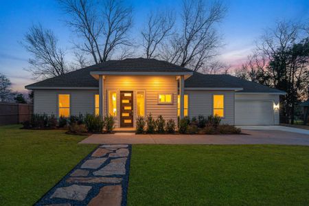 View of front facade with a garage and a lawn