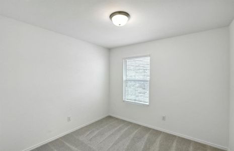 Secondary bedroom with large windows *real home pictured