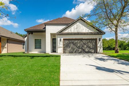 View of front of property with a front yard and a garage