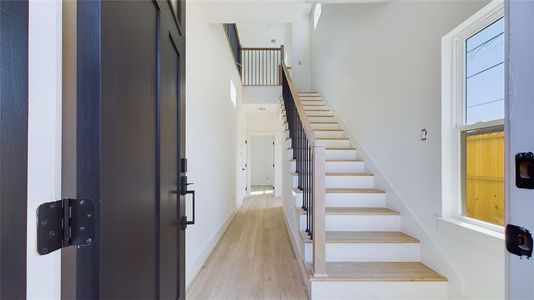 Guests are welcomed by a craftsman-style solid wood door with a divided light window. Inside, wood-like LVP flooring extends seamlessly throughout the home, bringing a touch of warmth and sophistication to every room.