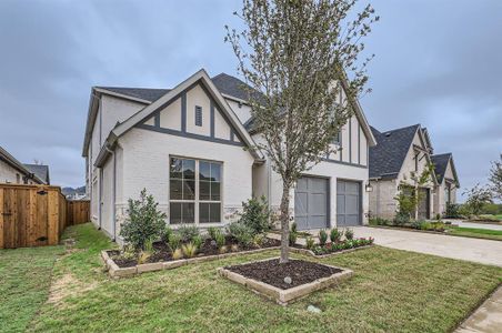 Tudor-style house featuring a front yard