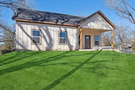 Back of house with a lawn and covered porch