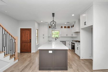 Upon entering, you will find the expansive 16'9"x13'9" kitchen to your left. An extremely well designed space, it offers two windows for natural light, high-end stainless steel appliances and solid white oak flooring!