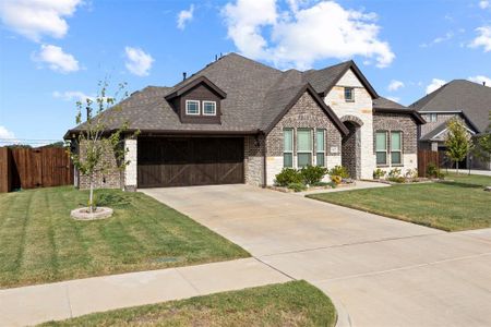 View of front facade with a garage and a front lawn