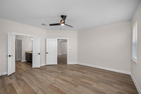 The primary bedroom with en-suite bathroom is a sanctuary of elegant sophistication. Refined finishes, and a tranquil color palette create a serene and inviting atmosphere perfect for rest and relaxation.