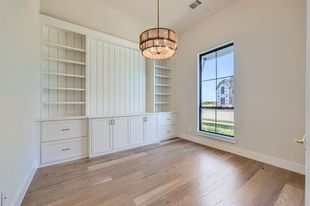 Unfurnished dining area featuring a chandelier and light hardwood / wood-style floors