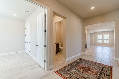 Hall featuring light wood-type flooring, baseboards, visible vents, and recessed lighting