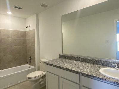 Full bath featuring toilet, visible vents, shower / washtub combination, and vanity