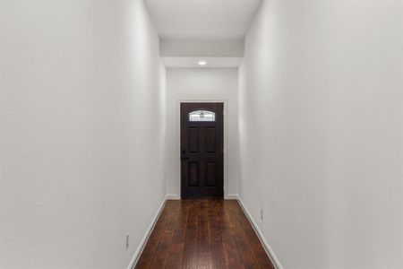 Doorway to outside with wood-type flooring