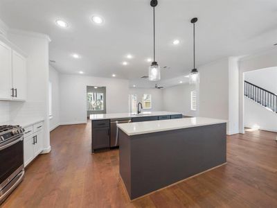 The kitchen is equipped with Stainless Steel LG Appliances (Microwave, Gas Range, Oven & Dishwasher). (Sample photos of a completed Warwick floor plan. The image may feature alternative selections and/or upgrades.)