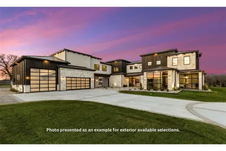 View of front of house with a garage and a lawn