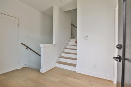 Step through the front door where stunning blonde wood floors create a warm and inviting atmosphere.