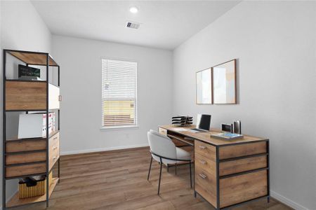 This den is the perfect spot for a home office! Featuring vinyl plank flooring, high ceilings, and a large window with privacy blinds.