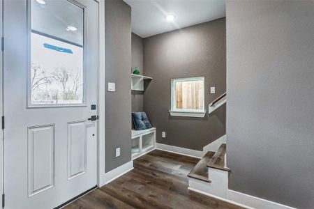 Welcoming entrance hall with a cozy seating nook, leading effortlessly to the second floor.