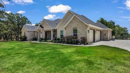 View of front of property with a front lawn and a garage