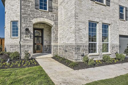 View of exterior entry with a garage