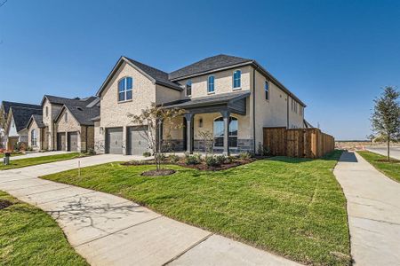 View of front of property with a front yard and a garage