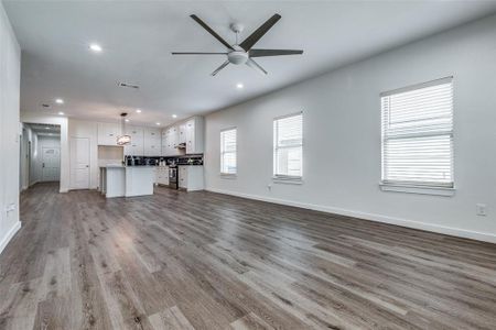 Unfurnished living room featuring light hardwood / wood-style floors and ceiling fan