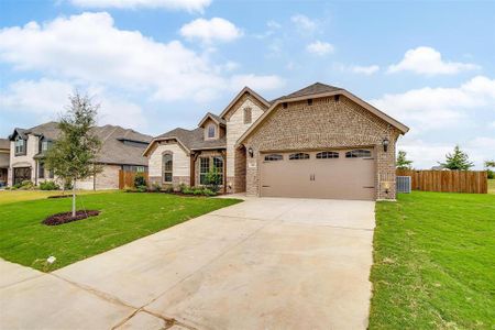 View of front of home with a garage and a front yard