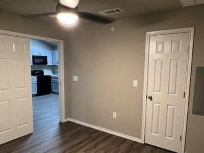 Hallway with dark hardwood / wood-style flooring