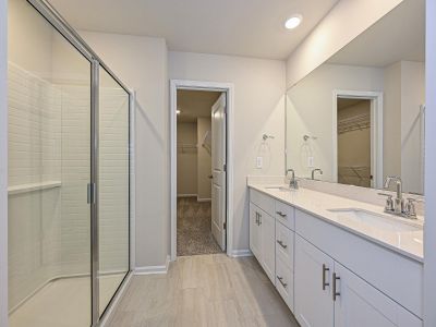 The primary bathroom offers dual sinks and a walk-in closet.