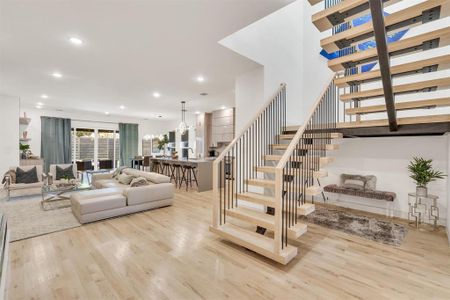 Staircase with an inviting chandelier and wood-type flooring