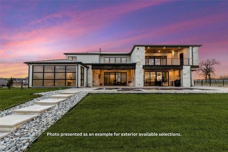 View of front of house with a yard and a balcony