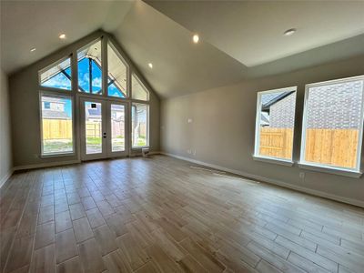 Pointed vaulted ceiling defines family room and covered patio.