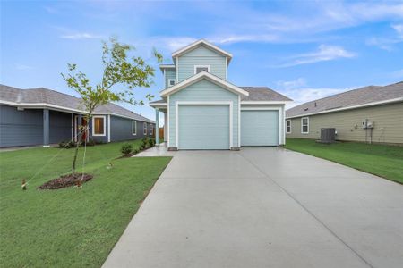 View of front facade featuring a garage and a front yard