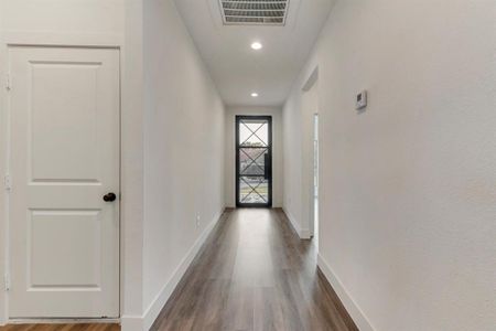 Corridor with dark hardwood / wood-style floors