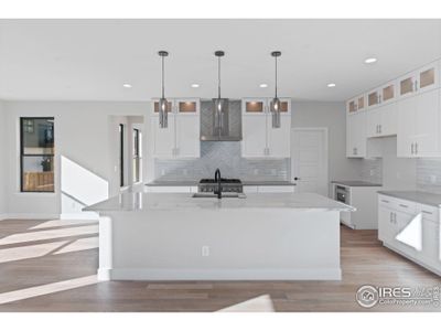 Custom Backsplash, Double Stacked Cabinets, Designer Lighting