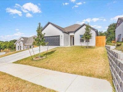 Ranch-style house featuring a garage and a front yard