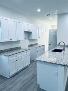 Kitchen with showing where the Range and Microwave will be place as well as view of the island.