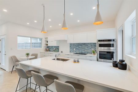 Large kitchen island with waterfall edge.