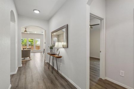 Hallway with hardwood / wood-style flooring