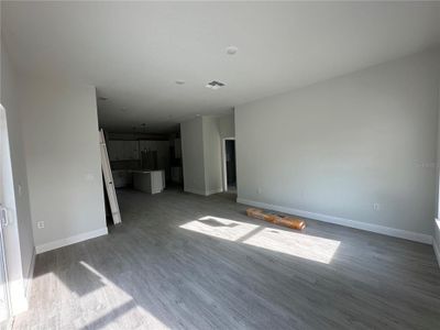 Living room looking towards kitchen. Primary bedroom is to the right.