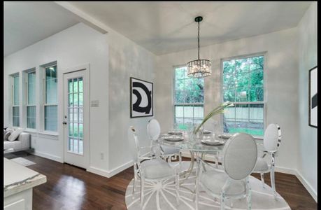 Dining room featuring dark hardwood / wood-style floors and a chandelier