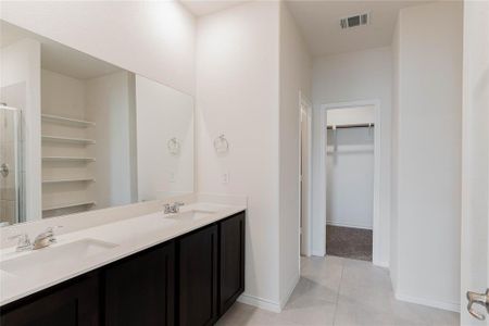 Bathroom with tile patterned flooring, vanity, and an enclosed shower